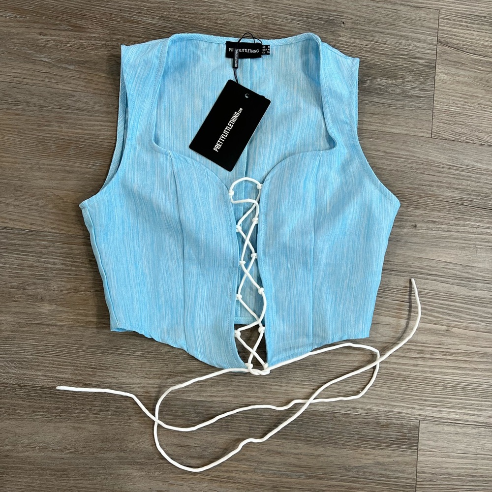 Brand new Pretty Little Thing Blue lace up crop top. Size 4.